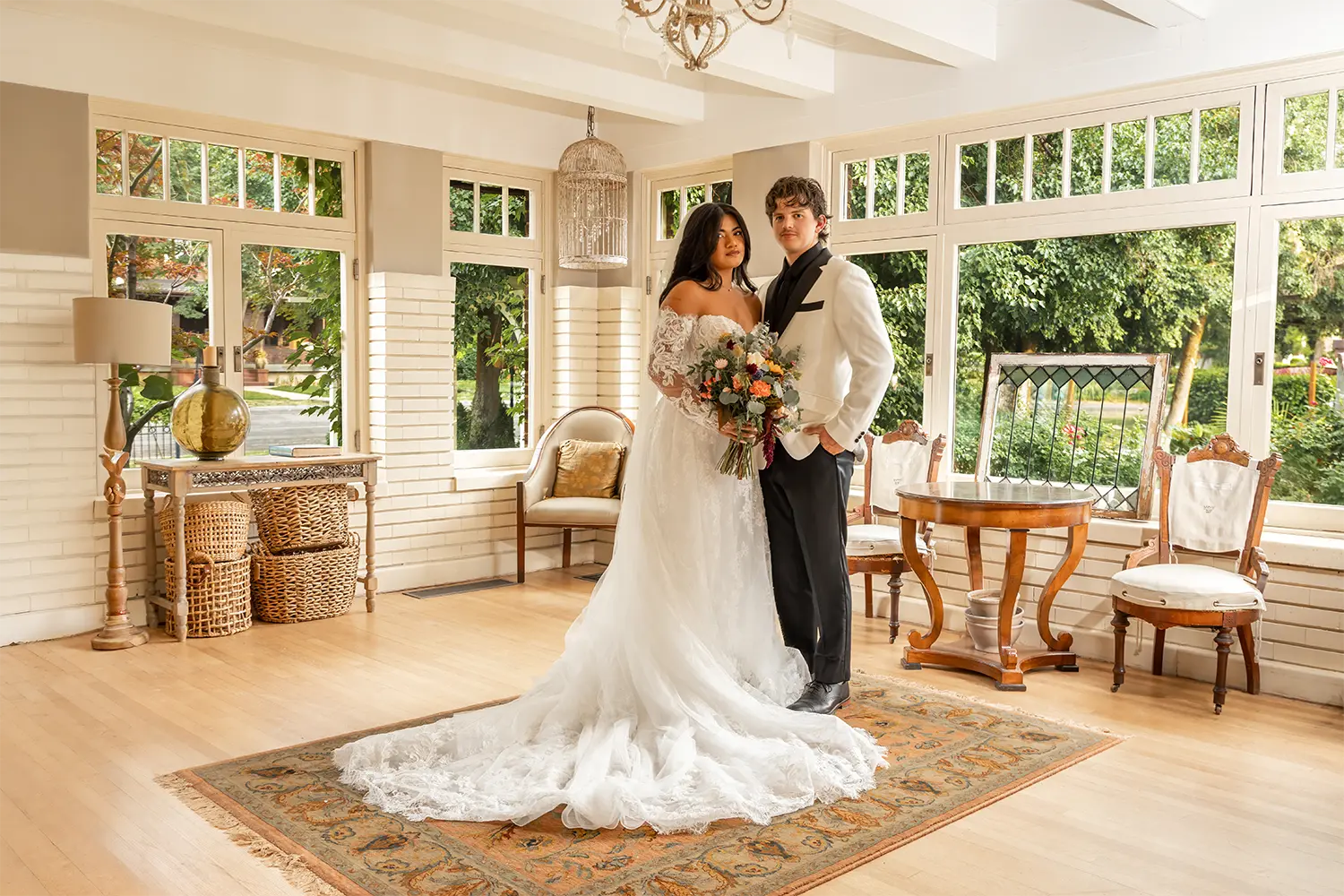 Bride and groom standing together indoors with a floral bouquet in Ogden Utah