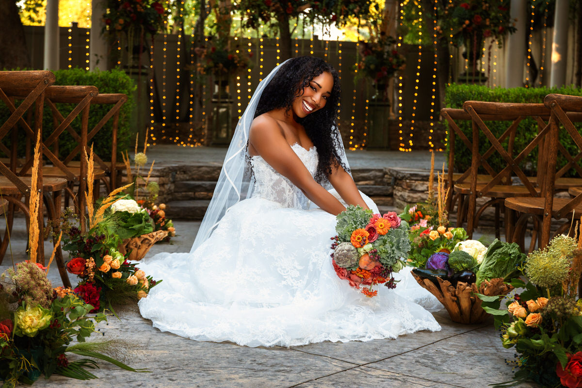 Close-up portrait of a bride smiling radiantly in a strapless lace gown from Just Girl Stuff during a bridal session by Masterpiece Images in Ogden, Utah.