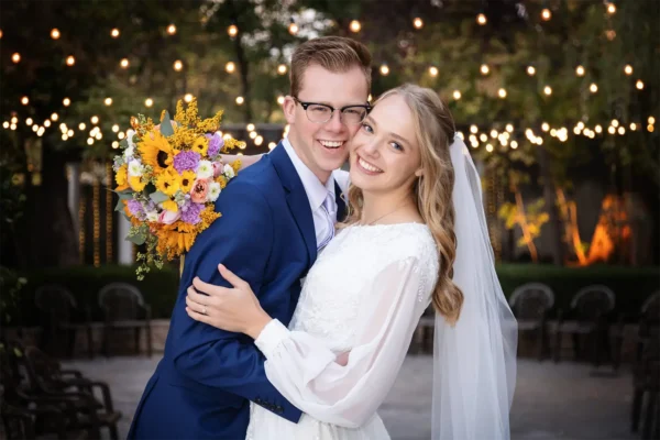 Smiling bride and groom sitting together at wedding reception