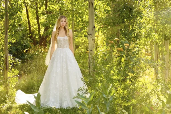 Bridal portrait of a bride standing in a grove of trees with sunlight during an outdoor wedding session by Masterpiece Images Ogden Utah